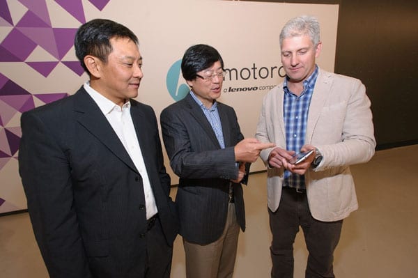 (from left to right)Liu Jun, EVP, Lenovo, President Mobile Business Group, Lenovo and Chairman of the Motorola Management Board; Yang Yuanqing, Lenovo Chairman and CEO; and Rick Osterloh, President and COO, Motorola Mobility celebrate the closing of Lenovo’s acquisition of Motorola Mobility today. Here Rick Osterloh demonstrates the latest features of the new Nexus 6 smartphone in front of the company’s new logo. 