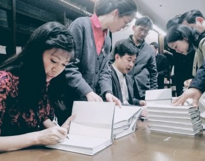 Nancy Liang and Chen Xianfa signing Poems in Nines