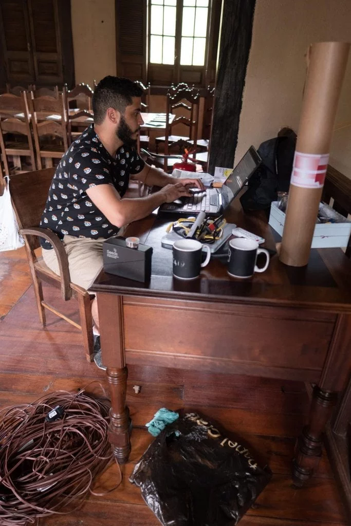 Future design thinking often means working in unusual venues: here, Allan Melo prepares to project art in a church using the projector mapping technique on his Lenovo Legion Y720.
