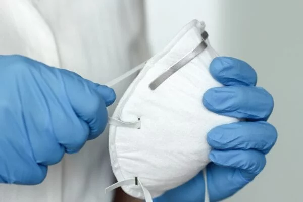 medical mask in gloved hands