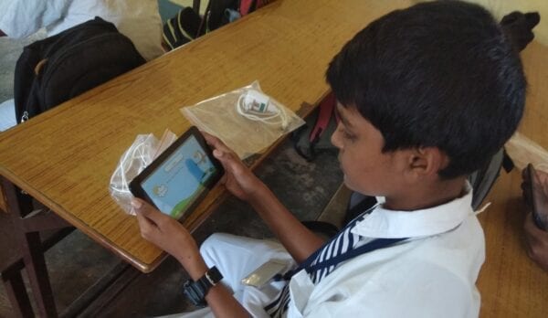 Young student using distance learning software on a tablet.