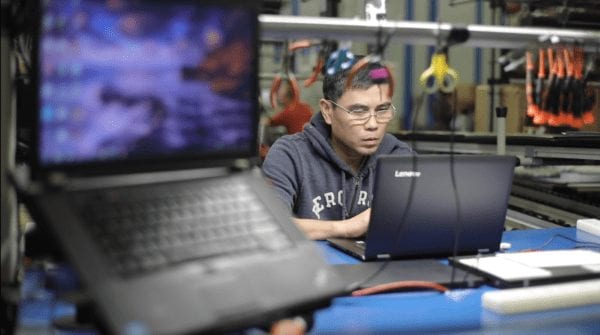 Lenovo employee checking PC in the Whitsett warehouse