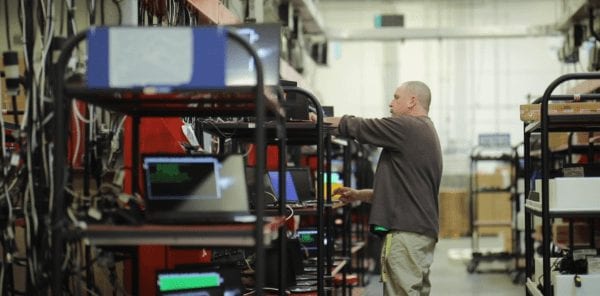 Lenovo employee checking racks of PCs in the Whitsett warehouse