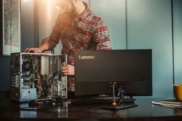 Lenovo Managed Services - person working with open Lenovo desktop PC and monitor