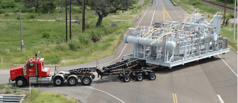 Lone Star Transportation truck towing a massive load of industrial equipment.