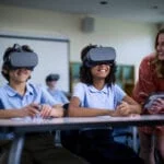 Young students wearing Lenovo VR headsets in school