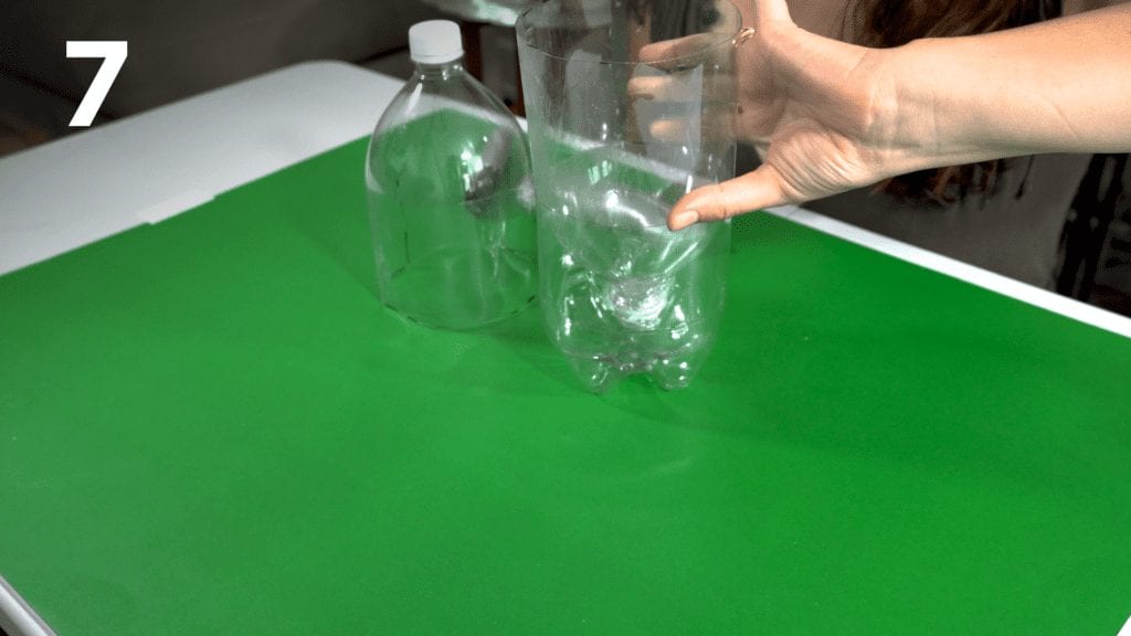 Flip the bottle with the plastic wrap and place inside the other piece of bottle. 