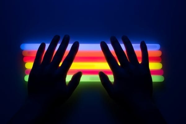 Lenovo brand image - shadows of two hands against a brightly colored light