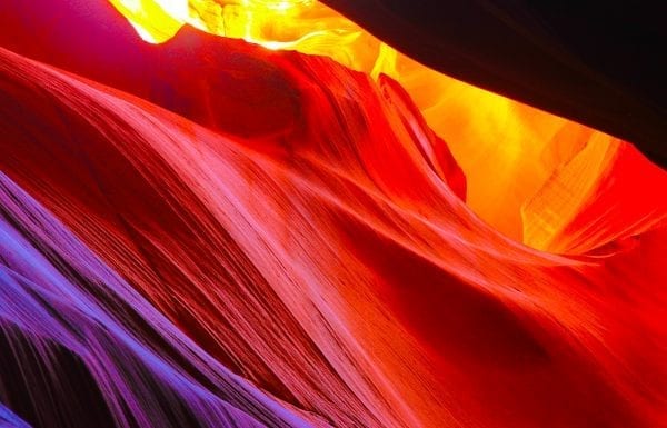Brand image - looking up through a deep, multicolored canyon
