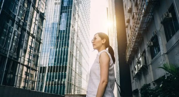 Lenovo brand image - woman standing alone surrounded by city skyscrapers