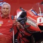 Ducati Team Manager Davide Tardozzi sitting beside a MotoGP bike