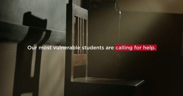 Text in image over empty chair: our most vulnerable students are calling for help