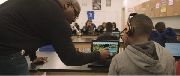 Teacher working with students in Baltimore using Lenovo devices to learn.