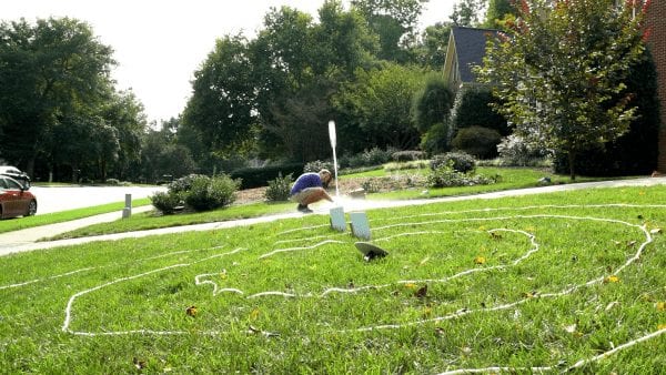 STEM at Home bottle rocket blasting off in a grassy yard