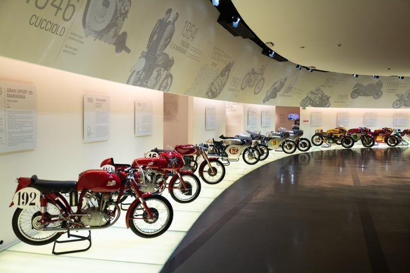 Museum display with a series of different iterations of Ducati motorbikes