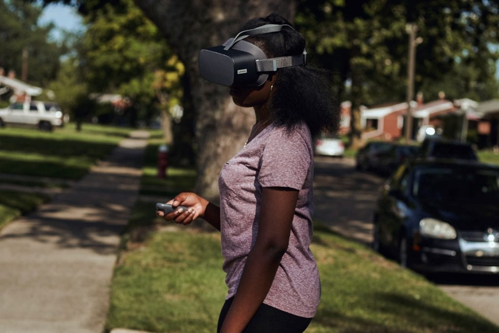 New Realities - USA - Kemi Dauda using a Lenovo VR headset outside