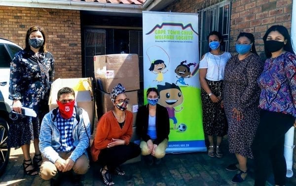 Volunteers standing by donations for the Cape Town Child Welfare Society
