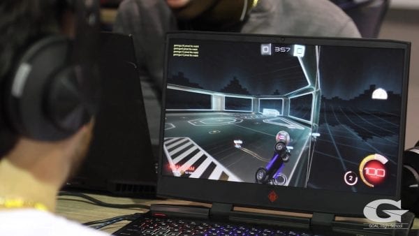 Over the shoulder shot of a video game being played on a laptop screen.