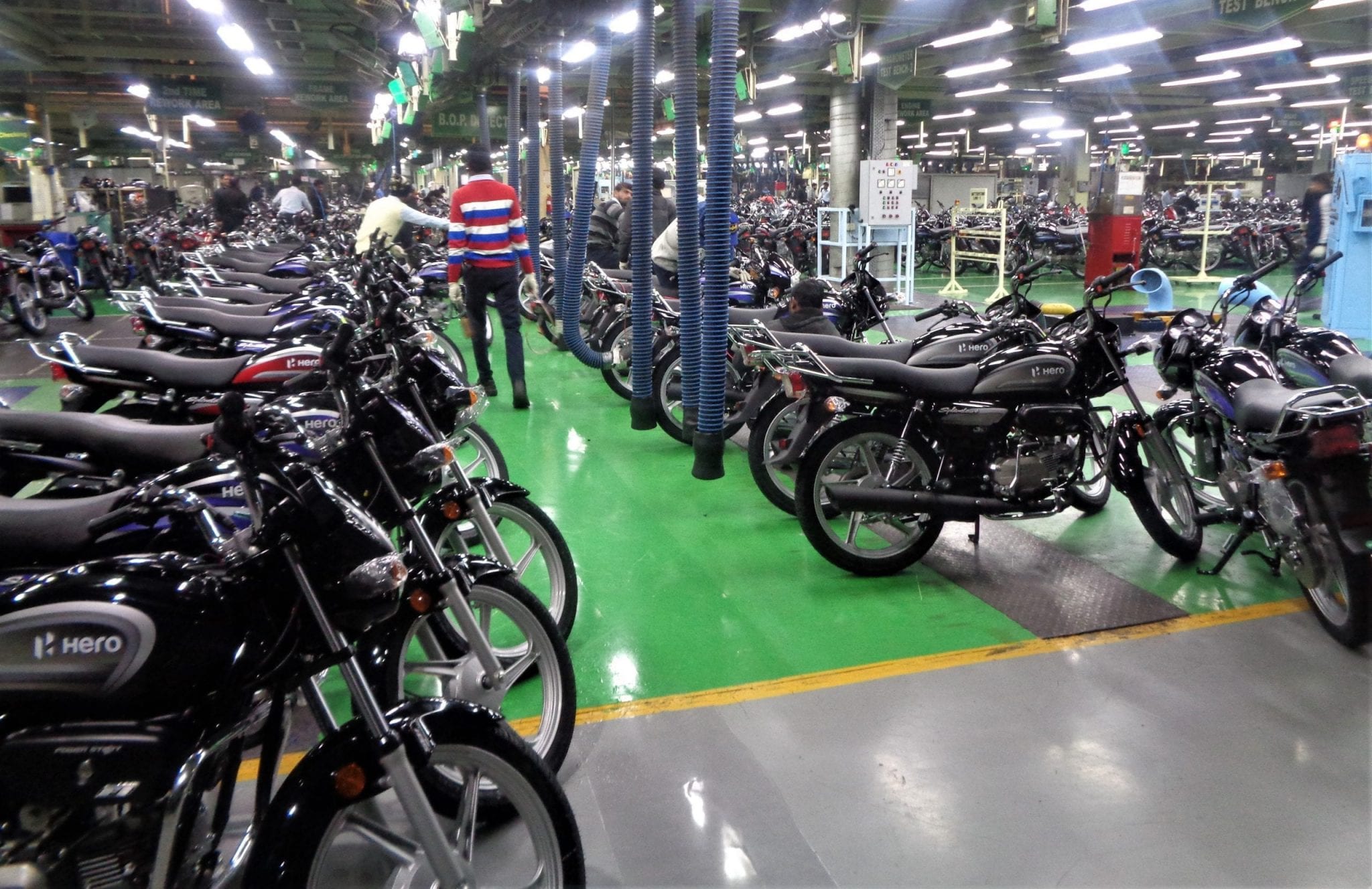 Hero MotoCorp warehouse with dozens of motorcycles lined up on display.