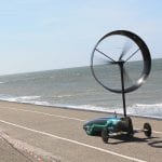 Wind-powered car by Chinook races along a coastline.