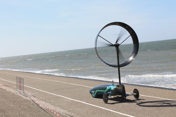 Wind-powered car by Chinook races along a coastline.