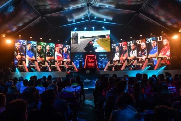 MotoGP eSport participants at a gaming event.
