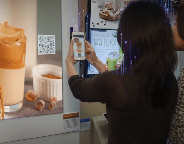 Lenovo ThinkIoT retail solution in action with a person reading a QR code with their phone