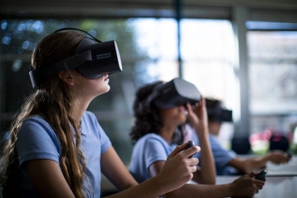 Young students using Lenovo VR headsets in school