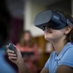 Young student wearing a Lenovo VR headset in school