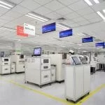 Lenovo's LCFC PC production facility, wide view of different stations in a bright, white warehouse