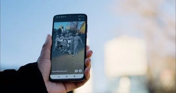 Smart phone held up with the MLK AR experience visible on the display