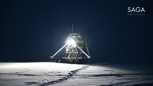 Lunark module sitting in the snow at night with bright light illuminating the surrounding snow.