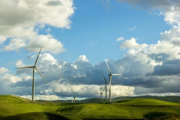 Lenovo brand image - wind turbines on low hills with a blue and partly cloudy sky
