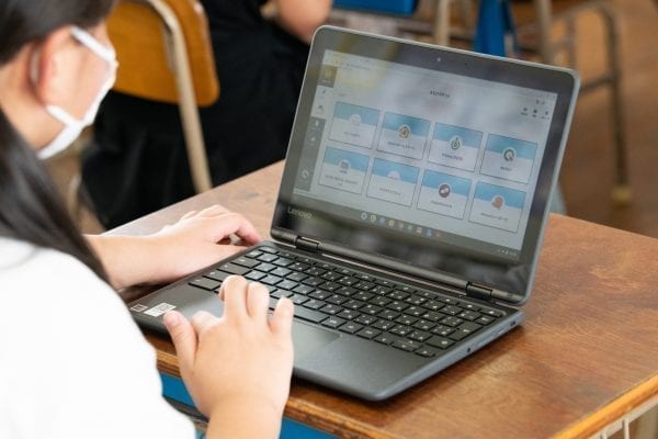 Japanese student using a Lenovo PC to do work in the classroom.