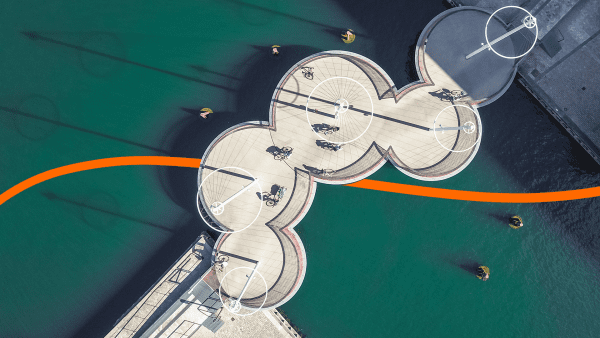 Lenovo Beyond Boundaries image - orange ribbon moving through an overhead shot of round bike paths