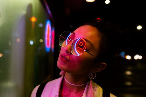 Tech World 2021: portrait of young woman under neon light