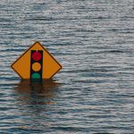 Traffic sign partially submerged in flood waters