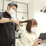 Japan salon with someone using a tablet while getting their hair cut