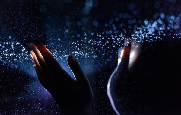 Lenovo brand image - hands raised out of the darkness to catch points of light