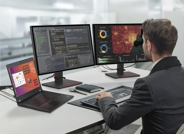Person working at a desk with a ThinkPad P17 and multiple monitors