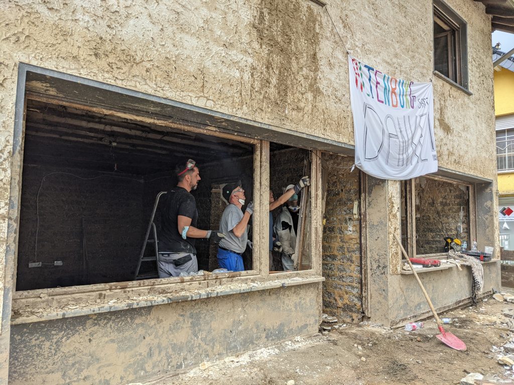 Lenovo volunteers working on a gutted building
