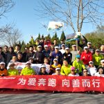 Lenovo China running team posing with large banner outside