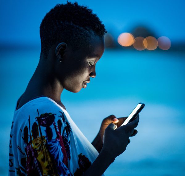 Young woman using smart phone at night