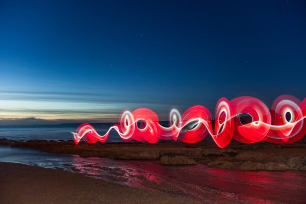 Brand image - red light spiral on an ocean shore