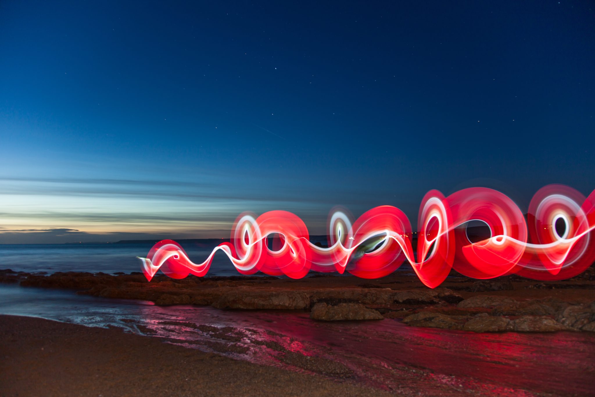 Brand image - red light spiral on an ocean shore - Lenovo StoryHub