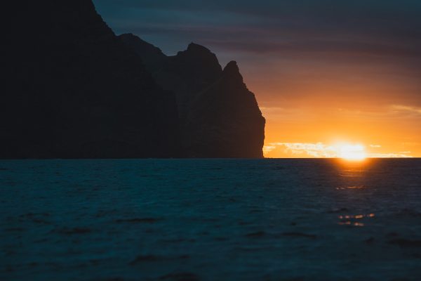 Wide shot from the ocean during sunset of Robinson Crusoe Island, Chile