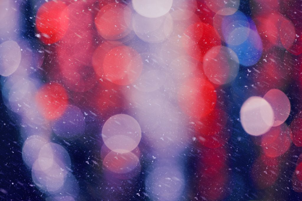 Brand image - Snowy night with red, blue and purple light bokeh.