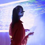 brand image - Woman looking at a wall projection of a digital code.