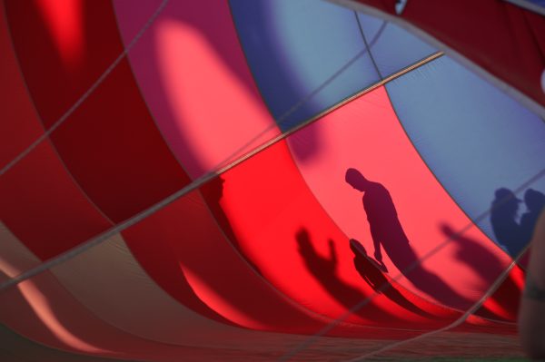 brand image - People silhouetted through a red and blue hot air balloon.