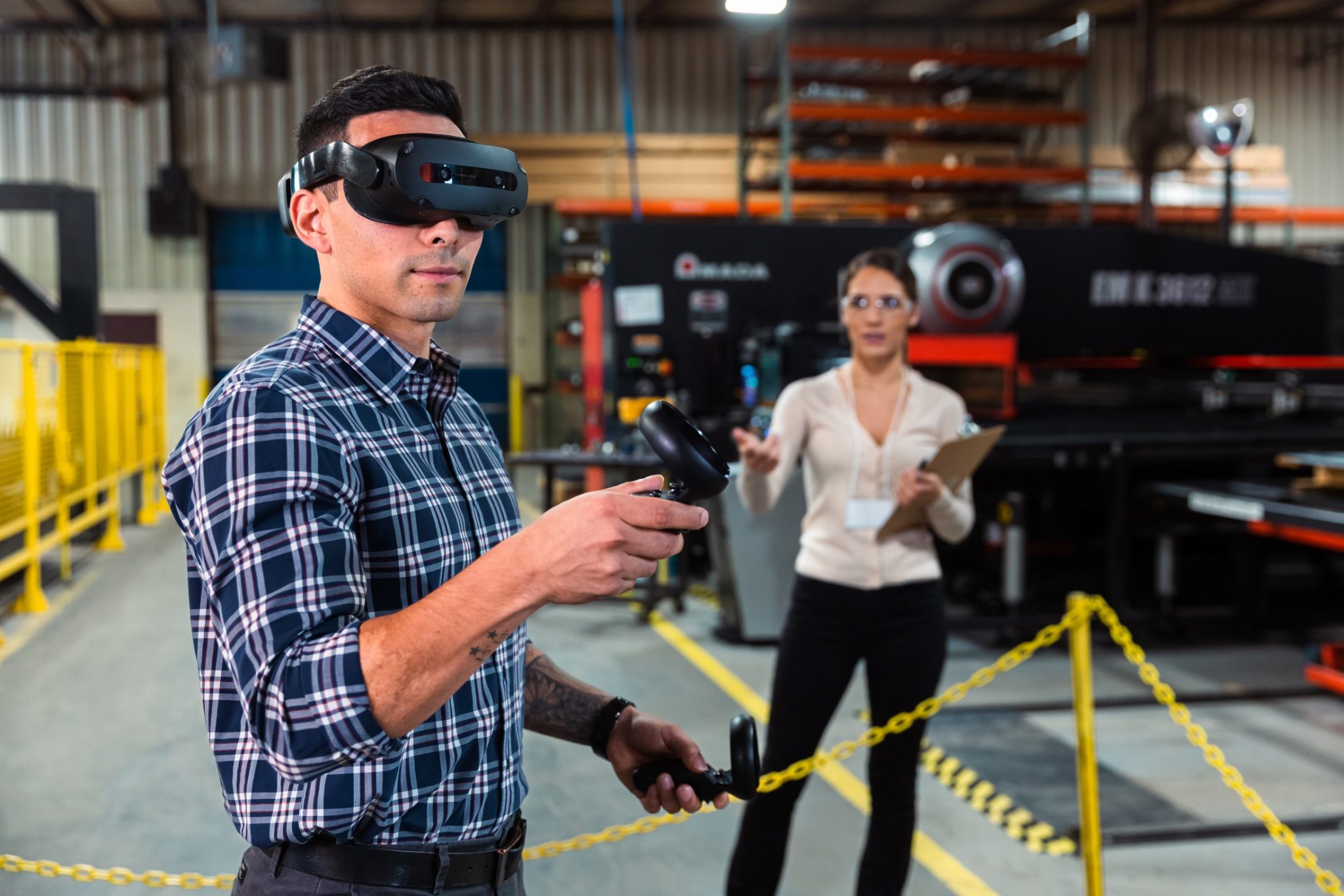 Person using the ThinkReality VRX headset on a factory floor